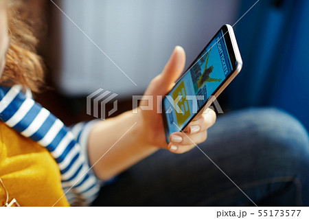 Closeup on young woman booking tickets on smartphone 55173577