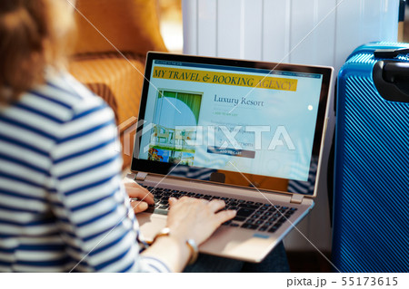 stylish traveller woman booking hotel on laptop stylish traveller woman booking hotel on laptop 55173615