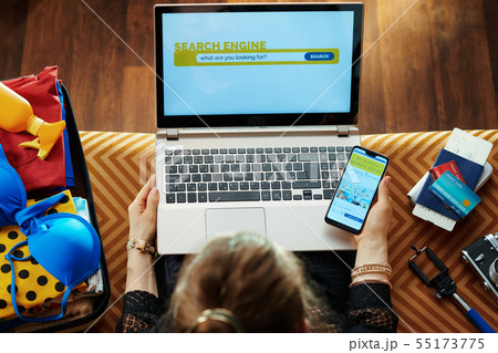 woman using online travel hotel booking site on smartphone woman using online travel hotel booking site on smartphone 55173775