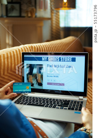 housewife with credit card buying shoes online on laptop housewife with credit card buying shoes online on laptop 55173796