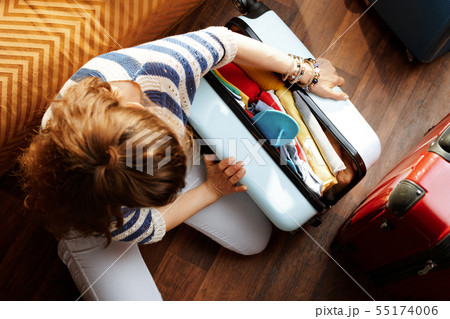 stylish woman closing over packed suitcase stylish woman closing over packed suitcase 55174006
