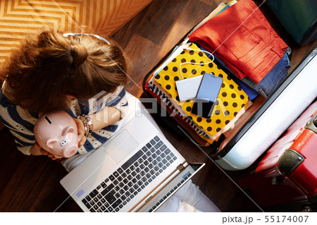 young woman holding piggy bank planning budget summer trip young woman holding piggy bank planning budget summer trip 55174007