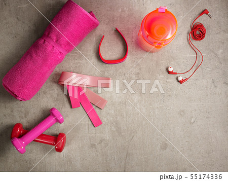 pink dumbbells, bottle of water, fitness tracker, elastic bands 55174336