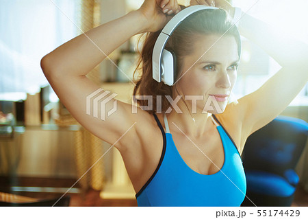 sports woman listening to the music with headphones sports woman listening to the music with headphones 55174429