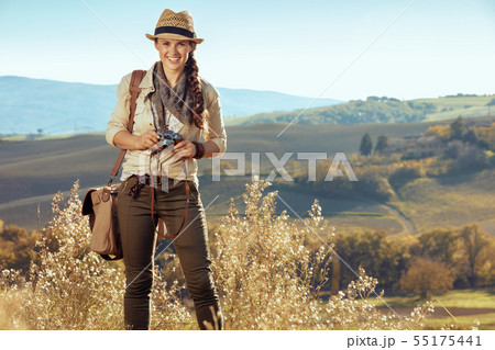 happy fit tourist woman with retro film photo camera 55175441