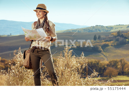 happy active tourist woman with map looking into distance 55175444