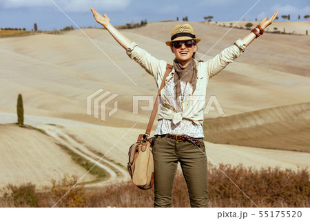 smiling fit woman on summer hiking in Tuscany ,Italy rejoicing 55175520