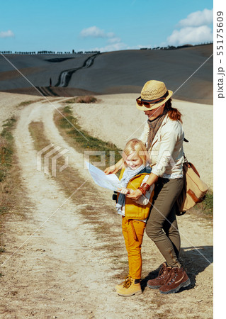 mother and child on summer hiking in Tuscany looking at map mother and child on summer hiking in Tuscany looking at map 55175609