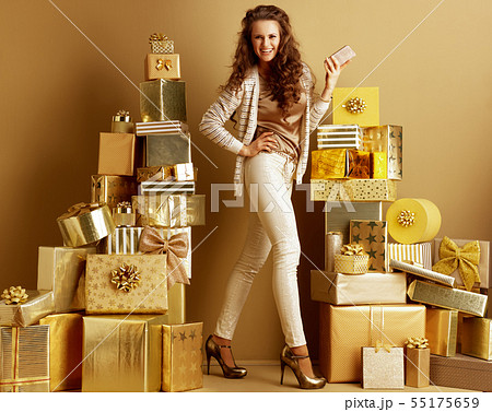 smiling trendy fashion-monger with smartphone 55175659