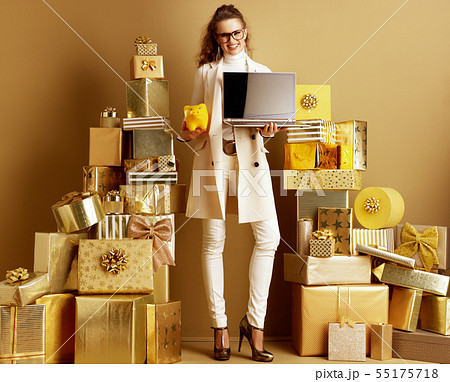 shopper woman showing laptop blank screen and yellow piggy bank shopper woman showing laptop blank screen and yellow piggy bank 55175718