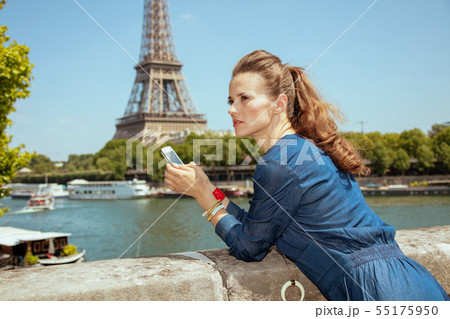 concerned solo tourist woman with smartphone using applications concerned solo tourist woman with smartphone using applications 55175950
