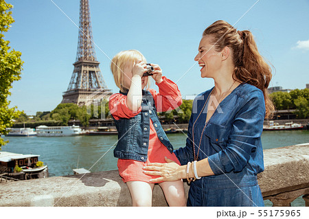happy mother and child travellers taking photo with camera 55175965