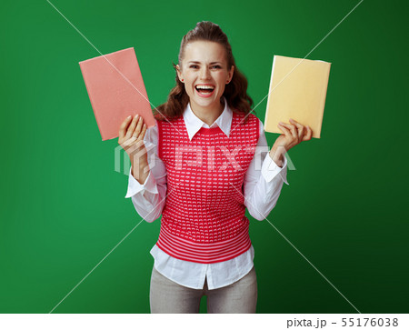 happy fit student woman showing two red and yellow books 55176038