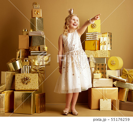 smiling young girl pointing at something smiling young girl pointing at something 55176259