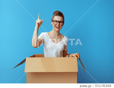 happy young woman in cardboard box got idea on blue happy young woman in cardboard box got idea on blue 55176309