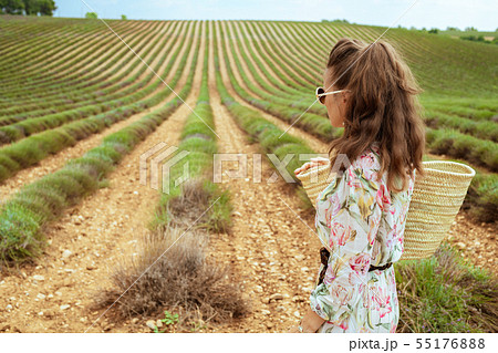 woman in green field in Provence, France looking into distance 55176888