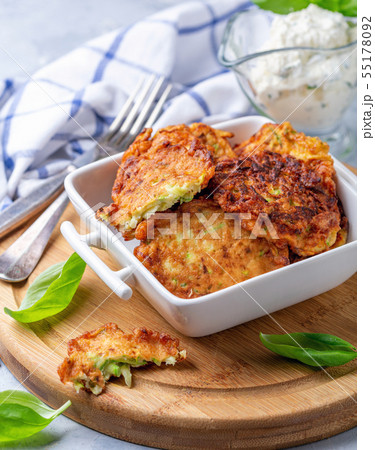 Zucchini fritters with sour cream sauce. Zucchini fritters with sour cream sauce. 55178092