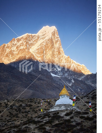 Stupa at sunrise near Dingboche village with prayer flags and mounts Kangtega and Thamserku, Nepal 55179234