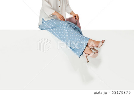 legs woman wearing high heels shoes sitting on bench. legs woman wearing high heels shoes sitting on bench. 55179379