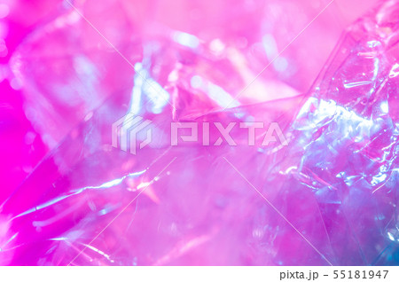 Holographic background in the style of the 80-90s. Real texture of cellophane film in bright acid Holographic background in the style of the 80-90s. Real texture of cellophane film in bright acid 55181947