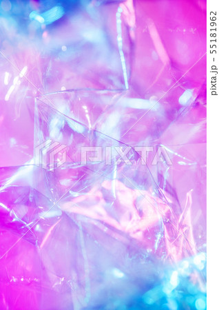 Holographic background in the style of the 80-90s. Real texture of cellophane film in bright acid 55181962
