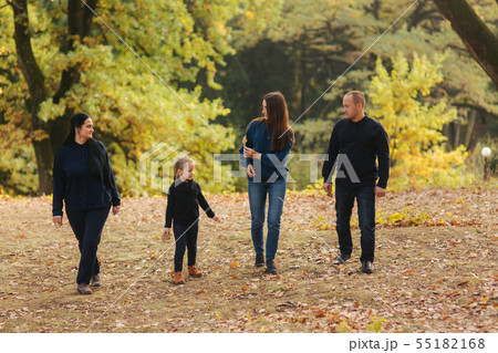 Happy family walking in the park. Mom dad and two daughter 55182168