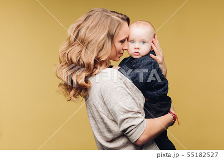 Laughing son and smiling mother in studio. 55182527