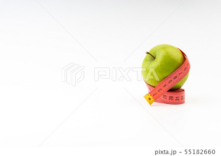 Green apple with red measuring tape. Selective 55182660