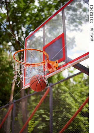 Basketball entering the hoop 55182931