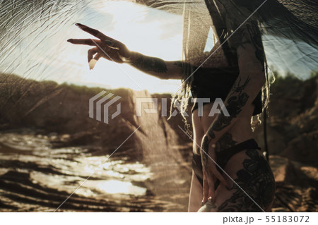 Beautiful sexy woman in black underwear. The body is covered with many tattoos. Dreadlocks on the Beautiful sexy woman in black underwear. The body is covered with many tattoos. Dreadlocks on the 55183072