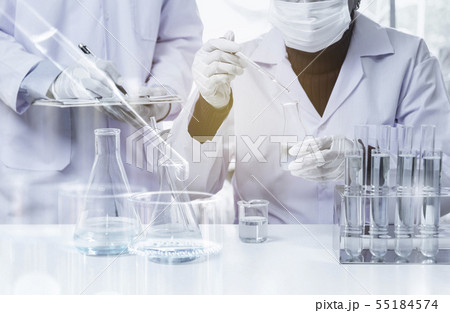 Researcher with glass laboratory chemical test 55184574