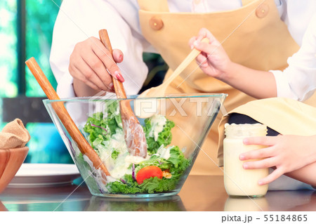 Happy family in the kitchen. Mom teaching kid 55184865