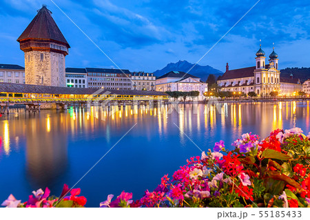 Lucerne. The famous Chapel, Kapellbrucke bridge at dawn in night lighting. 55185433