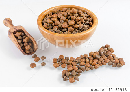 dog food in a bowl and snack like bone on white 55185918