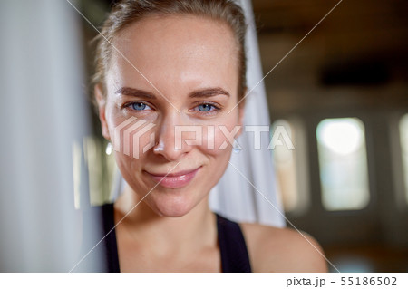 Instructor in aerial yoga portrait close-up. Hipster girl with an expressive look yoga trainer Instructor in aerial yoga portrait close-up. Hipster girl with an expressive look yoga trainer 55186502