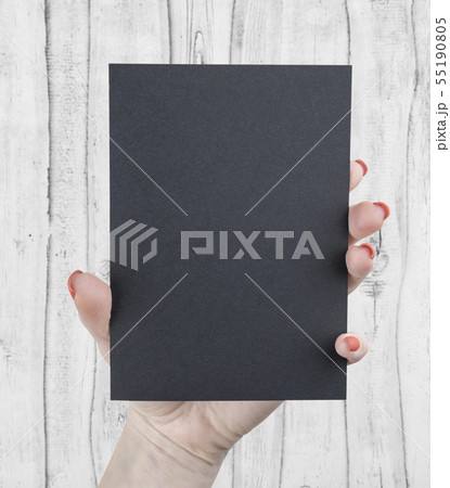 A woman holding black booklet 55190805