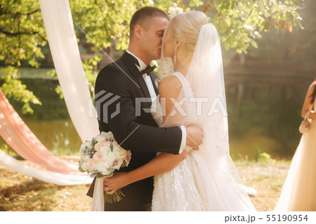 Just Married couple celebrate the end of wedding ceremony Background of recorated tree Just Married couple celebrate the end of wedding ceremony Background of recorated tree 55190954