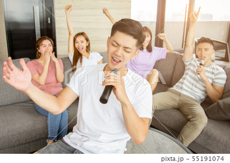 Group of friends playing karaoke at home Group of friends playing karaoke at home 55191074