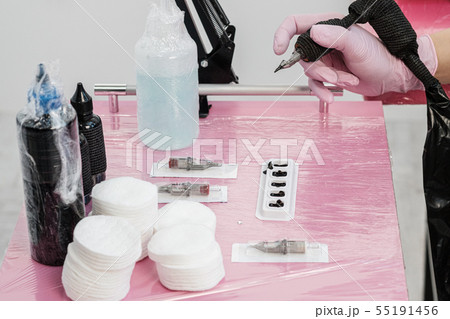 Close up of tattoo master tools. Needles, inks, petroleum jelly and disinfectant liquid. 55191456