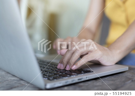 Woman is working with a smart phone and computer. Woman is working with a smart phone and computer. 55194925