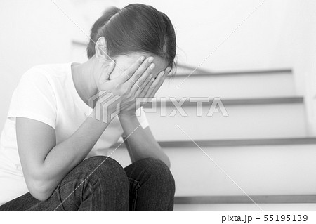 The depression woman alone sitting on staircase. The depression woman alone sitting on staircase. 55195139