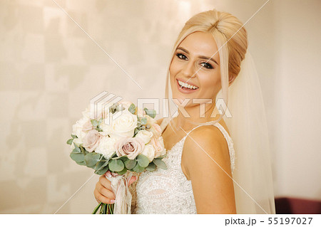 Portrait of gorgeous bride at home. Charming woman with bouquet. Morning of beautiful bride. Wedding Portrait of gorgeous bride at home. Charming woman with bouquet. Morning of beautiful bride. Wedding 55197027
