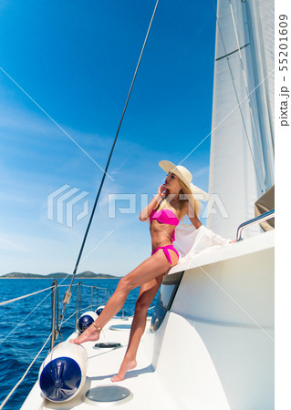 beautiful sexy woman in swimwear relaxing on a yacht 55201609