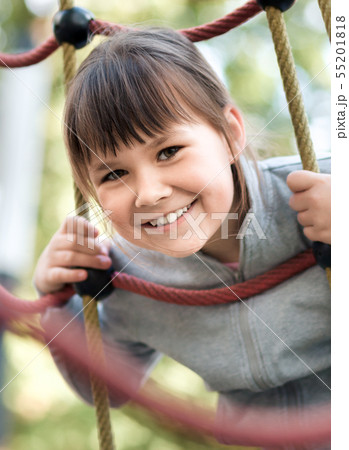 Cute little girl is playing in playground Cute little girl is playing in playground 55201818