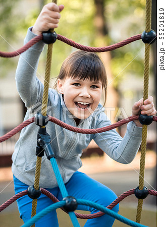 Cute little girl is playing in playground 55201819