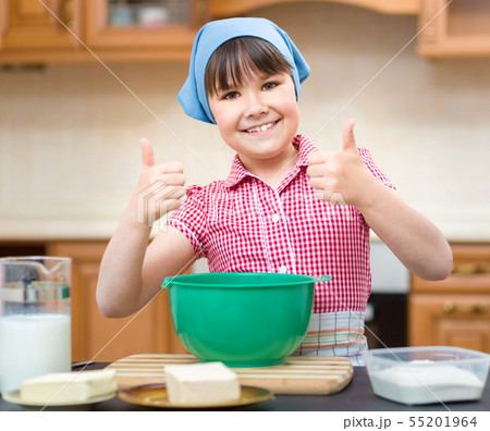Girl is cooking in kitchen Girl is cooking in kitchen 55201964