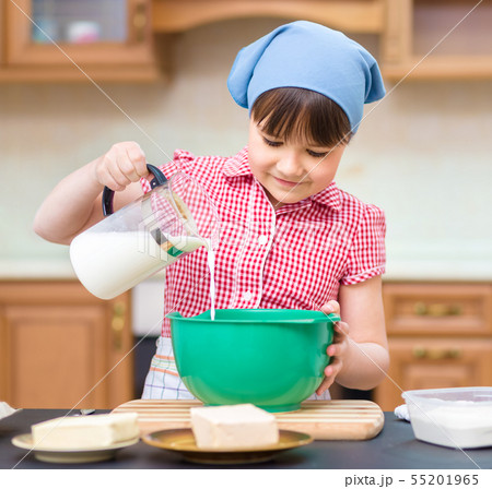 Girl is cooking in kitchen Girl is cooking in kitchen 55201965