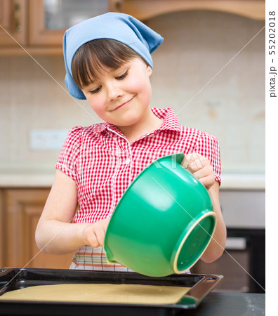 Girl is cooking in kitchen 55202018