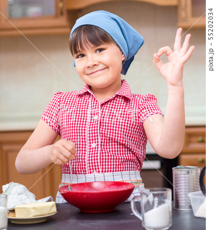 Girl is cooking in kitchen 55202034