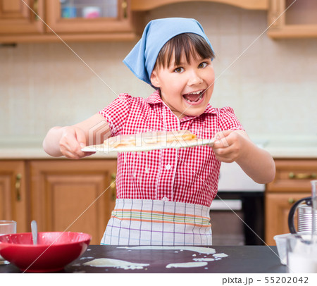 Girl is cooking in kitchen 55202042